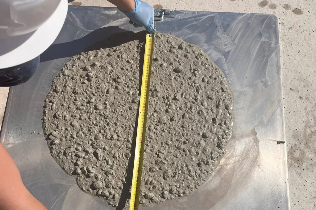 Concrete slump flow test being measured on a base plate