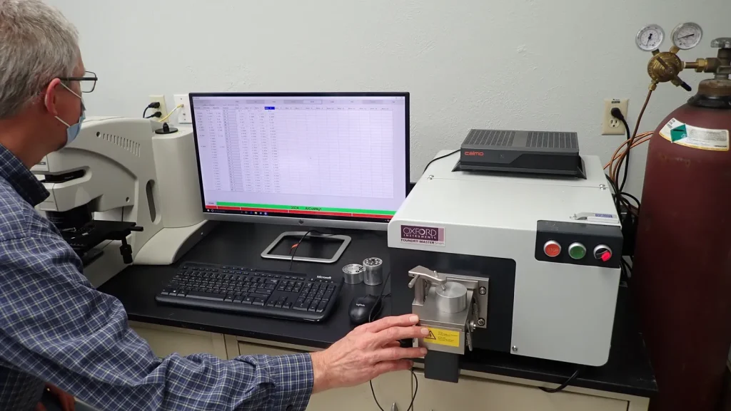 Material testing equipment supplier engineer running a spectrometer analysis