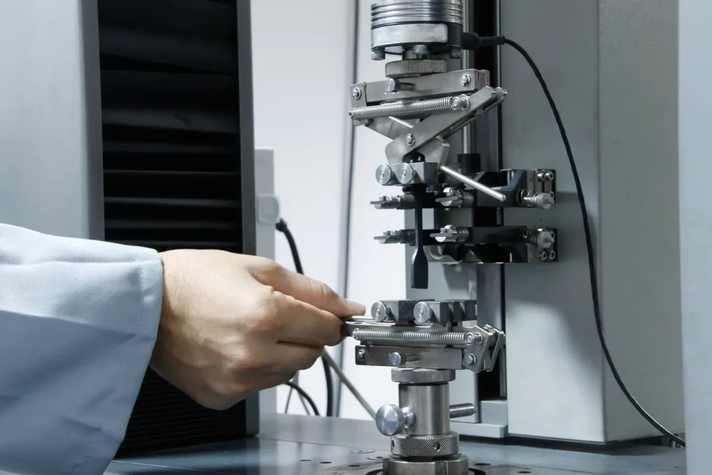 Plastic specimen clamped in tensile testing grips