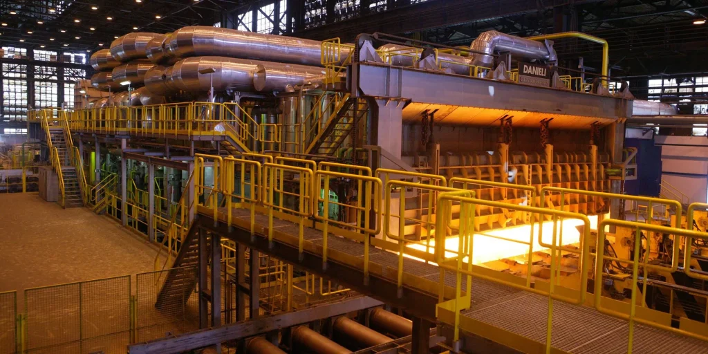 Hot steel leaving a reheating furnace in a rolling mill